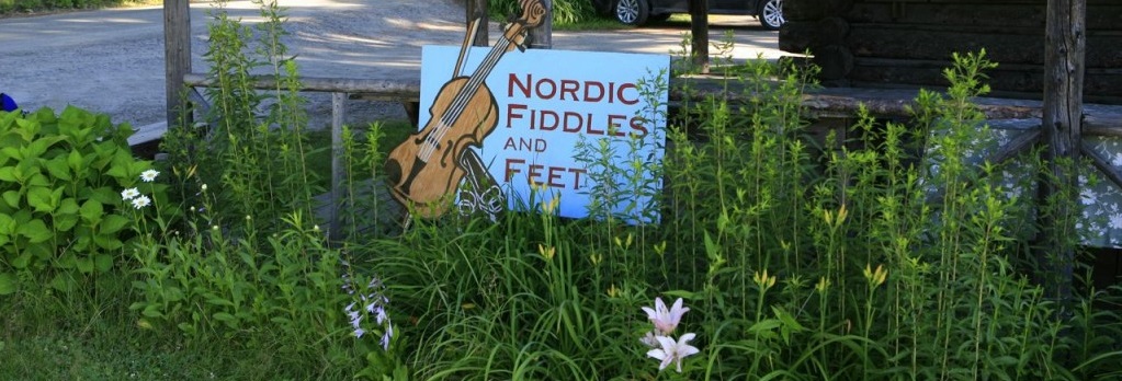 Camp welcome sign in a bed of flowers